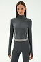 A woman wears the SPLITS59 Stevie Active Rib Half Zip in Heather Grey with matching high-waisted leggings featuring a striped elastic waistband, perfect for gym workouts, standing against a white background.