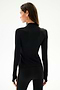 A woman with straight brown hair wears the SPLITS59 Isabelle Airweight Lite Mock Neck - Black/Creme, facing away from the camera against a plain light background.