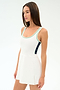 A woman in the SPLITS59 Martina Rigor Color Block Dress in White/Spearmint, a sleeveless athletic style perfect for court sports, stands against a plain white background.