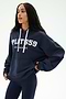 A person wearing the Stella French Terry Oversized Hoodie in indigo by SPLITS59, featuring "SPLITS59 Los Angeles" text and crafted from soft cotton fabric, paired with navy leggings while standing against a plain light background.