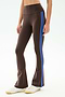 Model wears the SPLITS59 Raquel High Waist Supplex Flare in Dark Chocolate/Classic Blue, featuring blue side stripes and a comfy 4-way stretch fabric—ideal for gym workouts—paired with white sneakers against a plain backdrop.