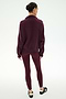 A person stands with their back to the camera on a plain white background, wearing the SPLITS59 Goldie French Terry Oversized Half Zip in Dark Cherry/Black, styled with matching maroon leggings and black slip-on shoes.