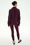 A person stands with their back to the camera on a plain white background, wearing the SPLITS59 Goldie French Terry Oversized Half Zip in Dark Cherry/Black, styled with matching maroon leggings and black slip-on shoes.