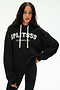 A woman is wearing the SPLITS59 Stella French Terry Oversized Hoodie in black with "Splits59 Los Angeles" text, paired with black leggings featuring white side stripes and white drawstrings, as she stands against a plain white background.