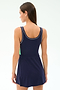 A woman with straight brown hair wears the SPLITS59 Martina Rigor Color Block Dress in Indigo/Spearmint, a sleeveless athletic style, shown from the back against a plain light background.