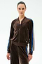 Warming up in the SPLITS59 Heritage Velour Bomber in Dark Chocolate/Classic Blue, she stands against a plain light background, pairing it with matching Heritage Velour Pants for effortless style.