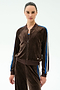 Warming up in the SPLITS59 Heritage Velour Bomber in Dark Chocolate/Classic Blue, she stands against a plain light background, pairing it with matching Heritage Velour Pants for effortless style.