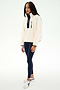 A woman stands against a plain white background wearing the SPLITS59 Reese Sherpa Half Zip Pullover in Creme/Indigo—crafted from 100% polyester—paired with navy leggings and white sneakers.