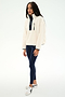 A woman stands against a plain white background wearing the SPLITS59 Reese Sherpa Half Zip Pullover in Creme/Indigo—crafted from 100% polyester—paired with navy leggings and white sneakers.