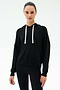 A person wears the SPLITS59 Joey Fleece Hoodie in black with white drawstrings and black spandex-blend leggings, standing against a plain white background.