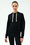 A person wears the SPLITS59 Joey Fleece Hoodie in black with white drawstrings and black spandex-blend leggings, standing against a plain white background.