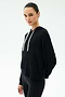 Person wearing the SPLITS59 Joey Fleece Hoodie in black—crafted from comfortable modal fabric for a soft, elevated feel—with white drawstrings and black pants, standing against a plain white background.