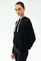 Person wearing the SPLITS59 Joey Fleece Hoodie in black—crafted from comfortable modal fabric for a soft, elevated feel—with white drawstrings and black pants, standing against a plain white background.