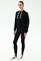 A person stands facing forward against a plain white background, wearing the SPLITS59 Joey Fleece Hoodie in black, black leggings, and white sneakers with black accents.
