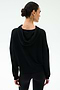 A woman with dark hair in a low bun is seen from behind wearing the SPLITS59 Joey Fleece Hoodie in black against a plain light background.