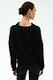 A woman with dark hair in a low bun is seen from behind wearing the SPLITS59 Joey Fleece Hoodie in black against a plain light background.