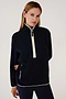 A woman wearing a SPLITS59 Libby Sherpa Half Zip in Indigo/Creme designed for winter workouts.