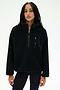 A woman wearing the SPLITS59 Reese Sherpa Half Zip Pullover in black, a soft polyester fleece with long sleeves and front pockets, stands against a plain white background.
