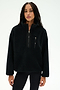 A woman wearing the SPLITS59 Reese Sherpa Half Zip Pullover in black, a soft polyester fleece with long sleeves and front pockets, stands against a plain white background.