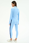 A woman wearing the SPLITS59 Tess Rigor Half Zip Waist Length jacket in Skylight with matching leggings and white sneakers, standing and facing away on a plain background.