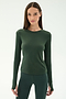 A woman wears the SPLITS59 Airweight Lite LS Waist Length top in Military, paired with matching spandex leggings, standing against a plain light background.