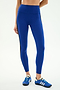 A person wears SPLITS59 Clare High Waist Rigor 7/8 leggings in cobalt/black, paired with blue athletic shoes, standing against a plain white background—ideal for intense gym workouts.