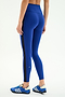 A person stands on a white background, photographed from behind, wearing SPLITS59 Clare High Waist Rigor 7/8 leggings in Cobalt/Black with a black side stripe and blue athletic shoes—ideal for gym workouts.