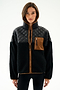 A woman wears the Skylar Sherpa Jacket - Black/Toffee by SPLITS59, featuring black fleece, 100% polyester, and brown pocket and trim, against a white background.