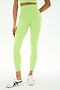 A person wearing SPLITS59 Sprint High Waist Rigor 7/8 leggings in Limeade, paired with a matching crop top and white sneakers, stands against a plain white background.