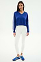 A woman faces forward, modeling the SPLITS59 Ellie Fleece V Neck Sweatshirt in cobalt/white with white sleeve stripes, paired with white leggings and blue athletic shoes, against a plain white backdrop.