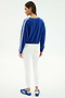 A woman faces away, wearing the SPLITS59 Ellie Fleece V Neck Sweatshirt in Cobalt/White with white leggings and blue athletic shoes, styled against a plain white background for a sporty look.