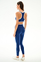 Woman wearing SPLITS59 Hayley Active Rib 7/8 - Heather Cobalt/White stands sideways in white sneakers against a plain white background.