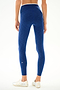 A person stands facing away in SPLITS59 Hayley Active Rib 7/8 - Heather Cobalt/White leggings and white sneakers against a white background.
