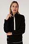 A woman wearing a SPLITS59 Libby Sherpa Half Zip in Black/Creme.