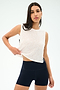 A woman wears the SPLITS59 Logan Mesh Tank With Stripe in White/Indigo and black athletic shorts, posing against a light background—an ideal breathable sportswear choice for your next workout.
