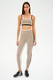 Dressed for gym workouts, the person is wearing a SPLITS59 Sam High Waist Rigor 7/8 set in Latte/Black and black sneakers.
