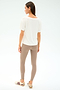 A woman faces away, wearing the SPLITS59 Georgia Jersey V-Neck in white and taupe spandex-blend leggings, paired with beige sneakers featuring maroon stripes, set against a plain light background.