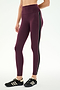A person wearing SPLITS59’s Margot Rigor Legging in Dark Cherry/Black—featuring a high-waisted fit with bold black and white side stripes and crafted from high-performance fabric—is paired with black Adidas sneakers, standing against a plain white background; an ideal look for intense gym workouts.