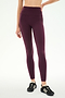 A person wearing SPLITS59 Margot Rigor Legging in Dark Cherry/Black, crafted from high-performance fabric, paired with black athletic shoes and standing against a plain white background—ideal for intense gym workouts.