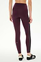 A person is shown from the back against a plain white background wearing SPLITS59 Margot Rigor Legging in Dark Cherry/Black, featuring a high-waisted fit, a black side stripe, and paired with black sneakers; the high performance fabric of these leggings makes them ideal for gym workouts.