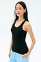 A woman with long dark hair wears the Splits59 Ashby Rib Tank in black and light blue pants, standing against a plain light background.