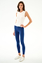 Woman standing against a white background, wearing the Nikki Jersey Tank - White by SPLITS59, blue textured spandex leggings, and white sneakers.