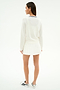 A person faces away, wearing the SPLITS59 Bekah Knit Cardigan in White/Indigo, paired with a white pleated skirt and white sneakers with black accents, set against a plain light background.