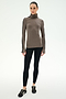 A woman stands facing forward against a plain white background wearing the SPLITS59 Jackson Rib Full Length Turtleneck in Lentil/Black, paired with black leggings and black sneakers.