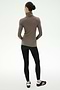 A person stands with their back to the camera against a plain white background, wearing the SPLITS59 Jackson Rib Full Length Turtleneck in Lentil/Black.