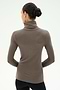 A person with dark hair in a bun wears the SPLITS59 Jackson Rib Full Length Turtleneck in Lentil, paired with black pants, standing with their back to the camera against a light background.