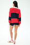 A person stands with their back to the camera, wearing the SPLITS59 Katie Fleece Rugby in Pirate Red/Indigo, black shorts, white socks, and white sneakers with red stripes.