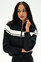 A person with long braided hair wears the SPLITS59 Morrison Nylon Twill Track Jacket in Black/Creme, featuring white horizontal stripes, standing against a plain light background.