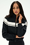 A person with long braided hair wears the SPLITS59 Morrison Nylon Twill Track Jacket in Black/Creme, featuring white horizontal stripes, standing against a plain light background.
