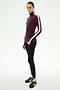 A person wears the SPLITS59 Jackson Rib Full Length Turtleneck in Dark Cherry/Creme, paired with black modal blend leggings featuring spandex for added stretch, and black sneakers, standing against a plain white background.